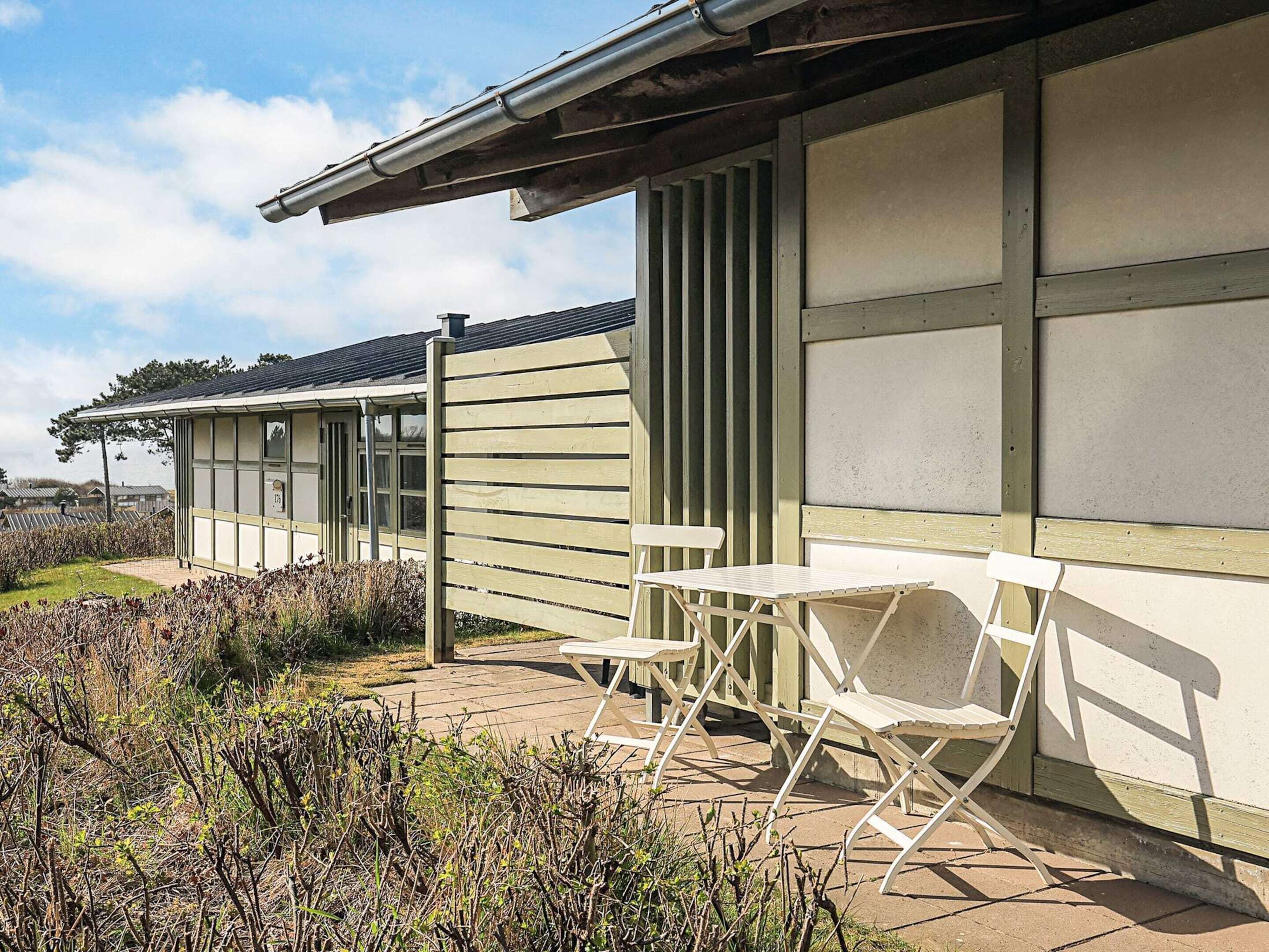 A building with a covered patio area featuring outdoor seating.