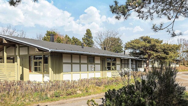 A row of single-story buildings with a simple, functional design, likely serving as a campground or small lodging facility. - 6 Person Holiday Home on a Holiday Park in Gilleleje (Gilleleje)