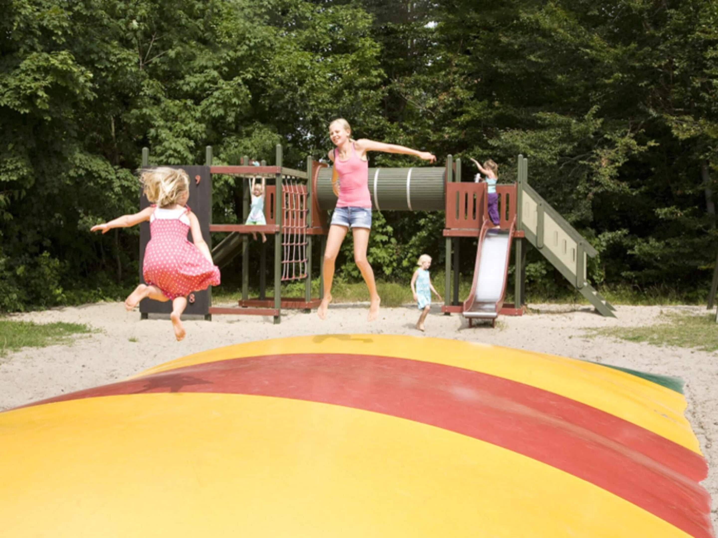A playground with a slide and climbing structures.