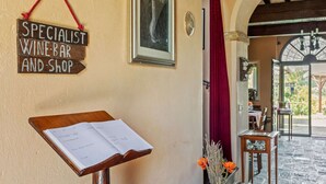 A wine bar sign, a menu board, a framed artwork, and a red curtain in a cozy interior space. - Rustic Holiday Home in Citta di Castello With Swimming Pool (Città di Castello)