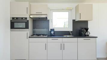 Enjoy cooking in this well-equipped kitchen with an oven, gas stove, and coffee maker.