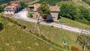 A rural property with a stone house, a small building with a tiled roof, and a swimming pool. - Flat on a Farm With Swimming Pool and Many Activities (Sant'Angelo in Vado)