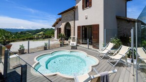 A two-story house with a swimming pool, outdoor seating, and a view of the mountains. - Flat on a Farm With Swimming Pool and Many Activities (Sant'Angelo in Vado)