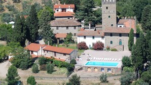 A historic building with a tower, a swimming pool, and surrounding greenery. - Lovely Estate not far From Florence With Olives Trees (Figline e Incisa Valdarno)