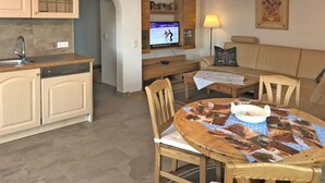 A compact living space with a kitchen, dining area, and seating area.