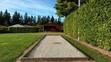 Enjoy a game of lawn bowls or croquet in the well-maintained outdoor area surrounded by trees.
