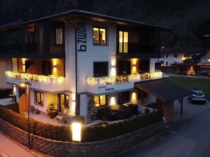 A multi-story building with balconies, a sign reading "Apartment Zillertal," and outdoor seating areas. - Spacious Apartment Near Ski Area in Mayrhofen (Schwendau)