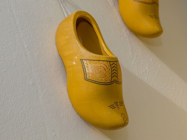A pair of yellow shoes with decorative patterns on a textured surface. - Attractive Apartment Near Vlissingen Beach (Vlissingen)