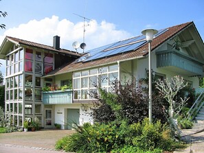 A two-story house with a balcony, solar panels, and a garden. - Welcoming Chalet Near Forest in Rohrnbach (Roehrnbach)