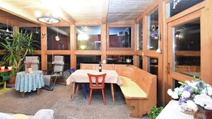 A cozy wooden interior with a dining table, chairs, and a bench. - Welcoming Chalet Near Forest in Rohrnbach (Roehrnbach)