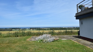 Ein Gebäude mit Blick auf ein Feld und den weiten Horizont.