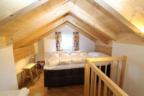 A bedroom with a loft bed, wooden beams, a small desk, and a window with curtains. - Luxurious Chalet in Kotschach-mauthen Near Ski Area (Kotschach-Mauthen)