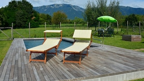 A wooden deck with two lounge chairs and a pool. - Modern Farmhouse in Pagnano Italy Near Forest (Asolo)