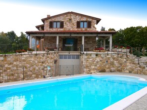 A stone house with a pool, featuring a stone facade, a balcony, and a garage. - Timeless Villa in Cagli With Garden and Swimming Pool (Cagli)