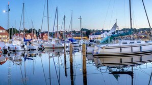 A marina with various boats docked, surrounded by buildings and a clear sky. - 4 Person Holiday Home in Allinge (Allinge)