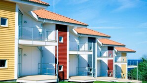 A row of modern, multi-story buildings with balconies, likely part of a hotel or resort. - 6 Person Holiday Home in Allinge (Gudhjem)