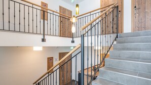 A staircase with metal railings and wooden steps, leading to an upper floor. - Luxury Chalet in Saalbach-hinterglemm With Sauna (Saalbach-Hinterglemm)