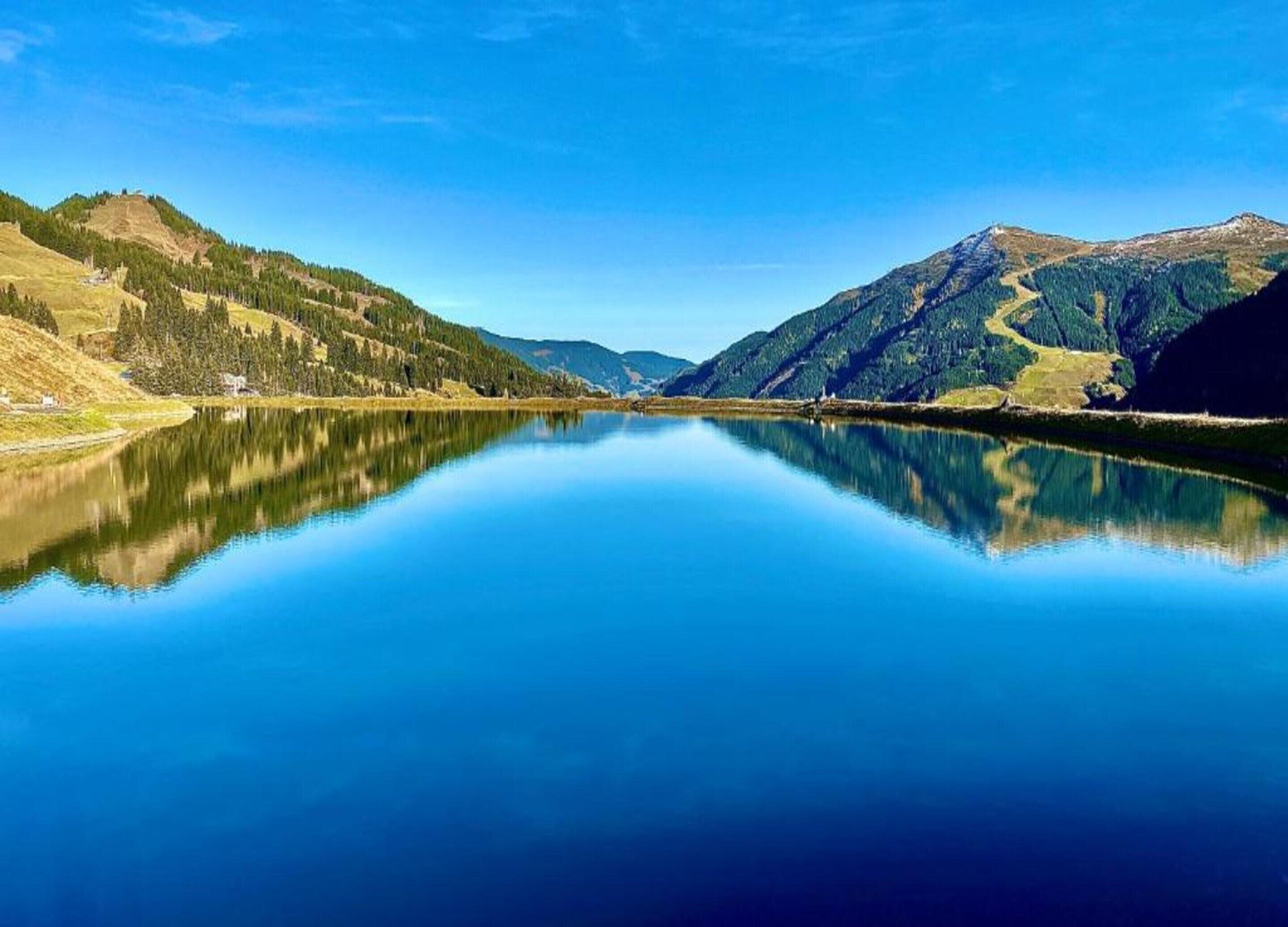 A tranquil lake with mountains in the background.