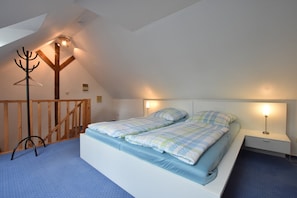 A bedroom with a bunk bed, a wooden coat rack, and a desk with a lamp. - Lovely Apartment in Stellshagen With Garden (Damshagen)