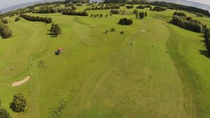 An aerial view of a golf course with sand bunkers, trees, and a small building. - Lovely Apartment in Stellshagen With Garden (Damshagen)