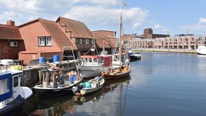 A harbor with boats docked, buildings with red roofs, and a clear sky. - Lovely Holiday Home in Zierow With Terrace (Zierow)