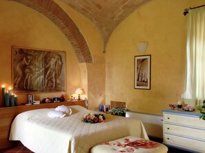 A hotel room with a bed, a dresser, a painting, and a lamp. - Vintage Mansion in Montepulciano With Pool (Montepulciano)