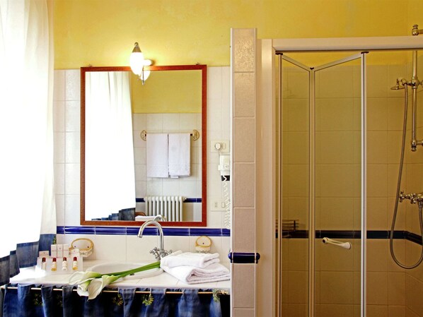 A bathroom with a sink, mirror, towel rack, shower, and a light fixture. - Vintage Mansion in Montepulciano With Pool (Montepulciano)