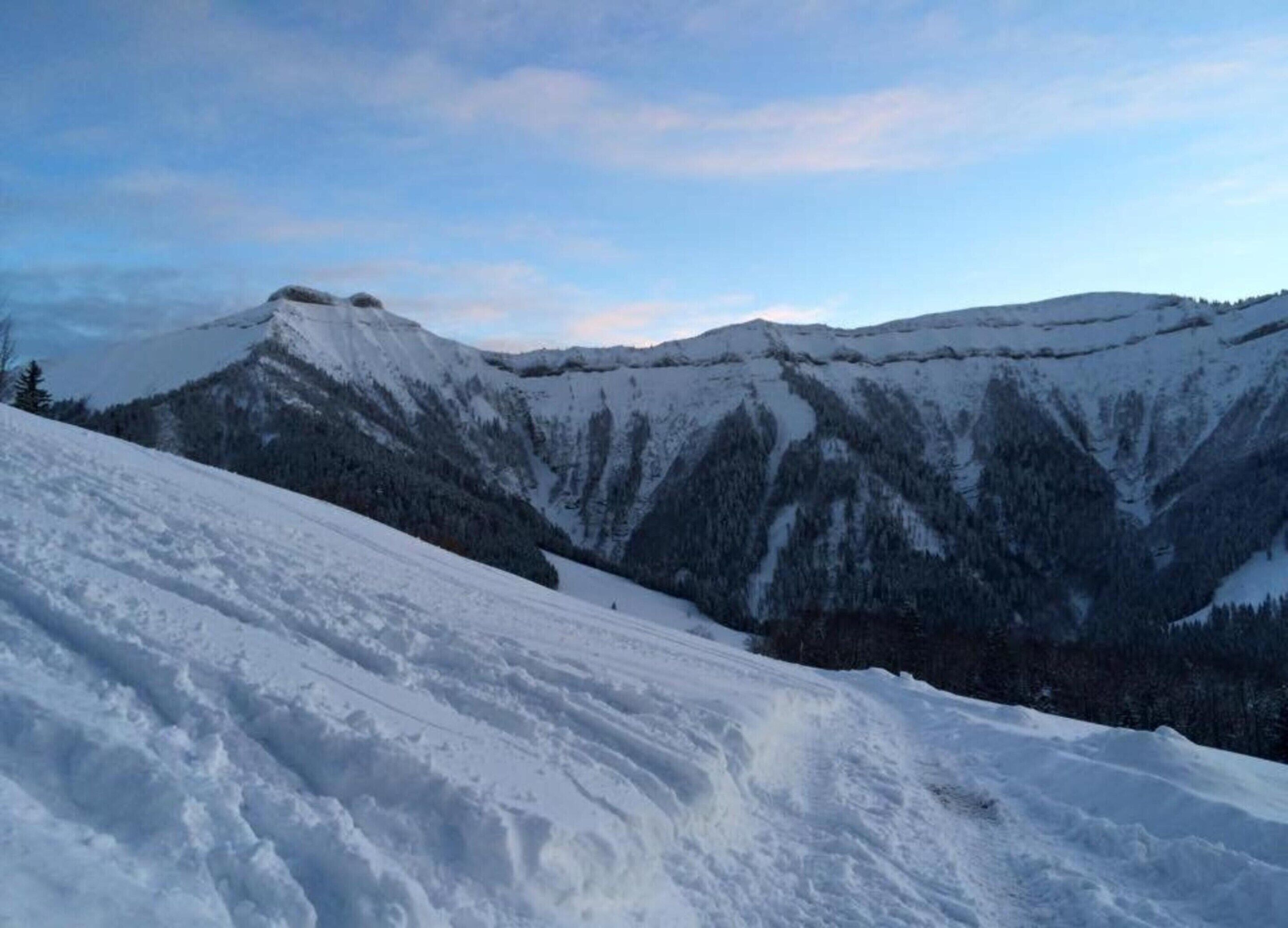 A snow-covered mountain landscape with a clear sky.