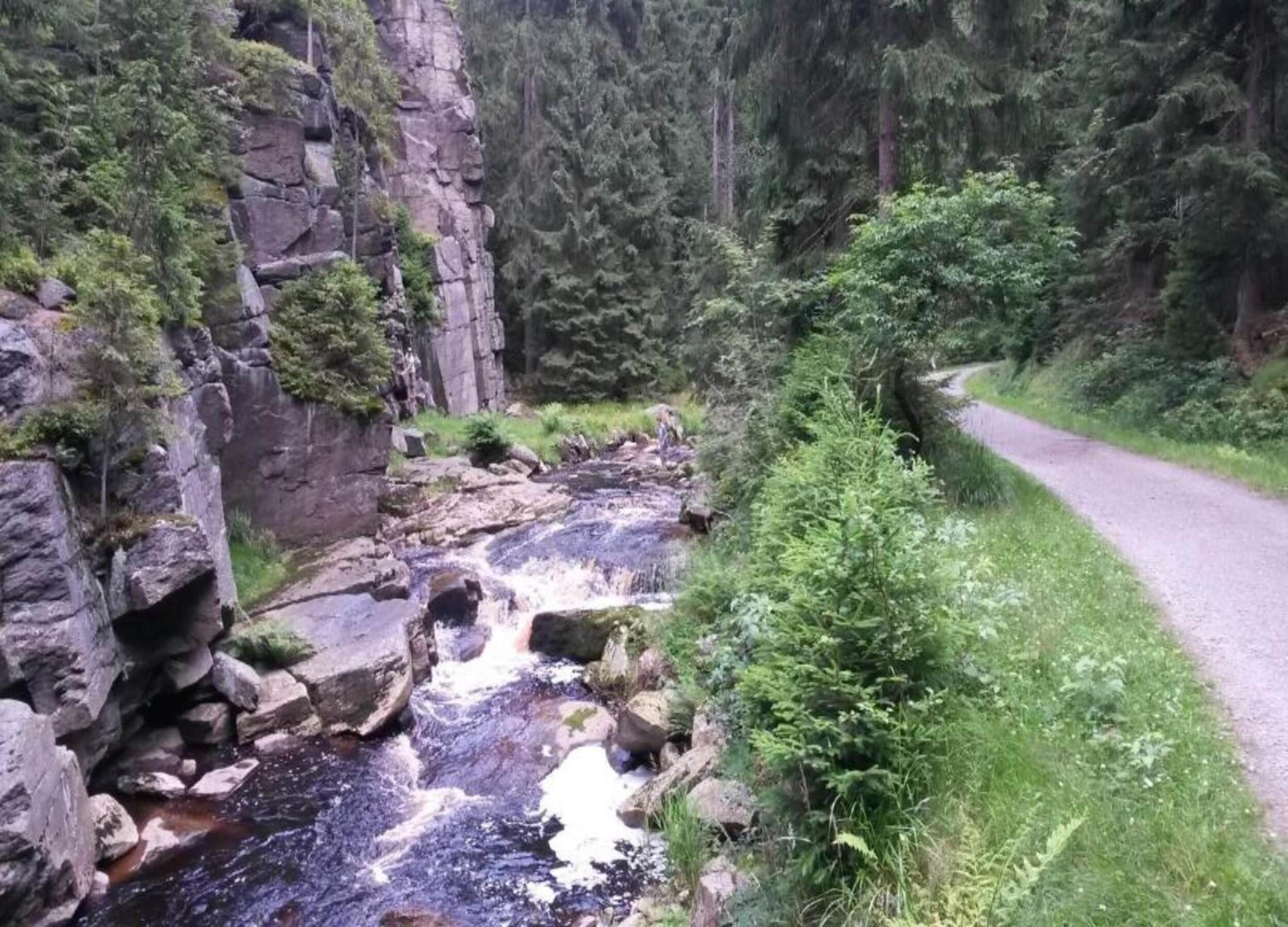 A rocky stream with a road curving alongside.