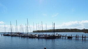 A marina with multiple sailboats docked at wooden piers. - Cozy Holiday Home in Rerik With Terrace (Rerik)