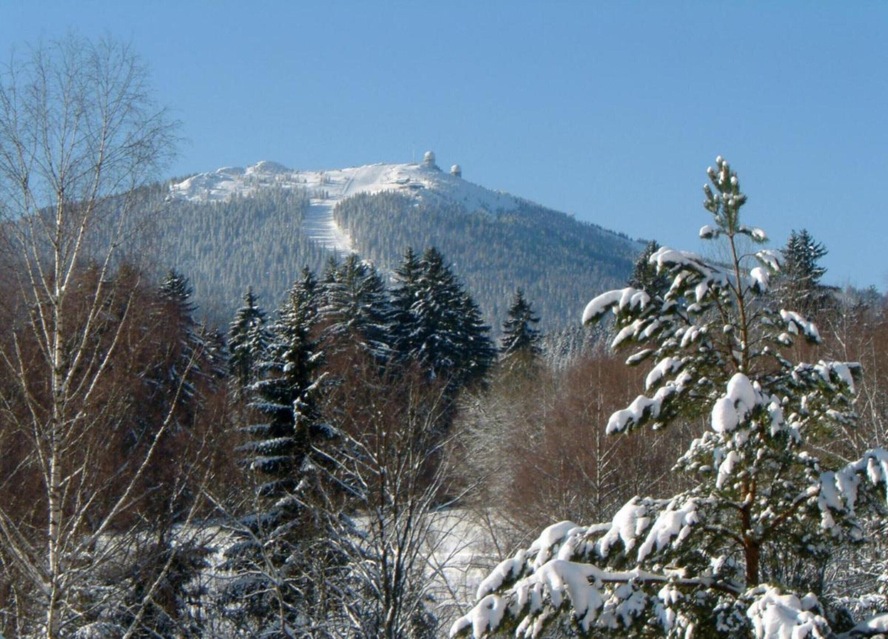 A snowy mountain landscape with a clear sky.