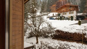 A wooden building with a snow-covered landscape and a mountain in the background. - Modern Apartment in Kitzbuhel Near Ski Area (Kitzbuhel)
