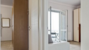 A room with a sliding glass door leading to a balcony with outdoor seating. - Amazing Holiday Home Near Pet-friendly Beach (Carrara)