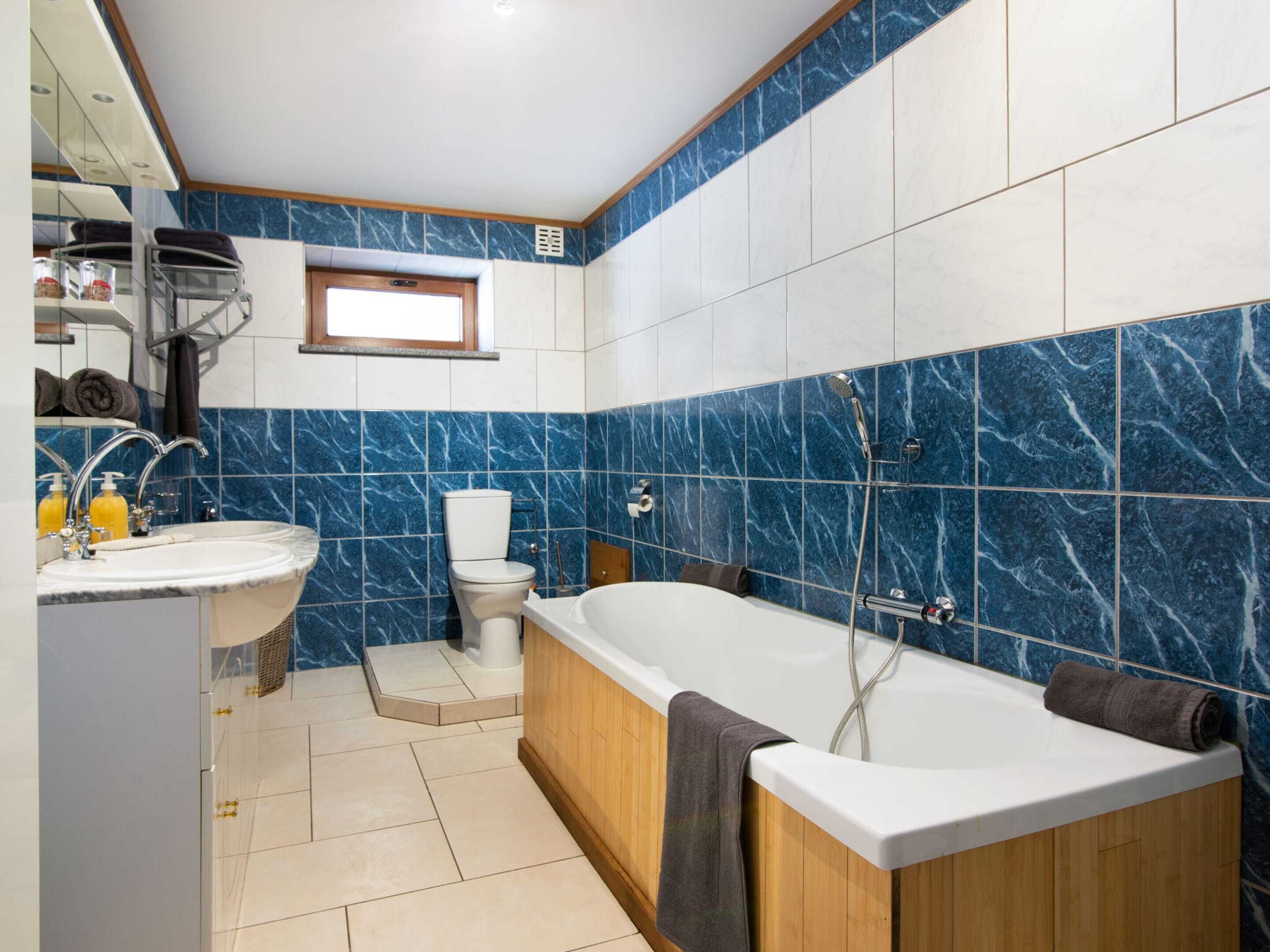 Ein modernes Badezimmer mit Badewanne, Toilette und Waschbecken.
