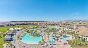 A resort with multiple swimming pools, sun loungers, and a well-maintained lawn area.