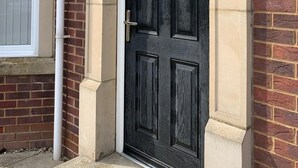 A black door with a sign above it that reads "Jubilee Court apartments 2-7". - Luxury 2-bedroom apartment  in sleepy Filey on the North Yorkshire coast  (Filey)