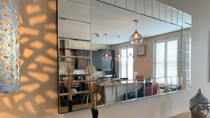 A modern kitchen with a large mirror, pendant lights, and a decorative vase. - Luxury 2-bedroom apartment  in sleepy Filey on the North Yorkshire coast  (Filey)