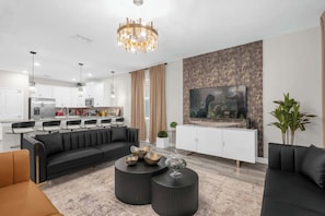 A modern living room with a sofa, coffee table, and TV.