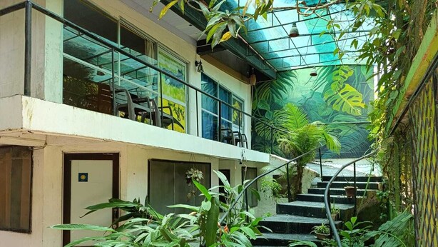 A multi-level building with a staircase surrounded by lush greenery. - Amazonas Explorers Leticia (Leticia)