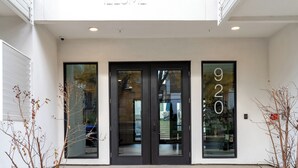 A modern building entrance with a glass door and a large number '920' on the right.