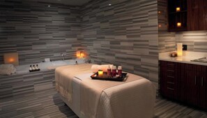Relax in a serene space with a cushioned seating area, water feature, and aromatherapy essentials.