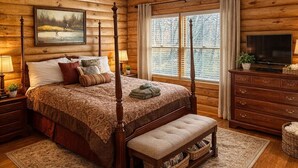 A log cabin bedroom with a four-poster bed, a bench, a television, and a large window with curtains.