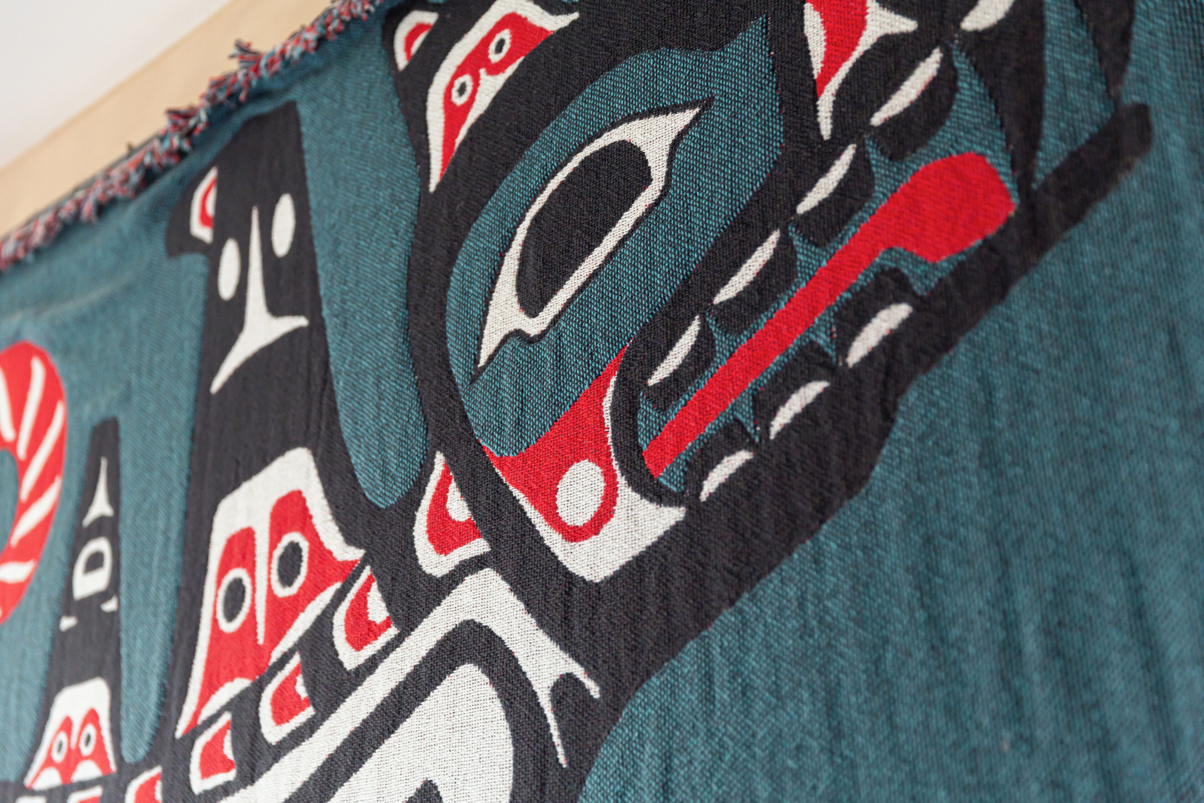 A close-up of a textile with a detailed indigenous pattern.