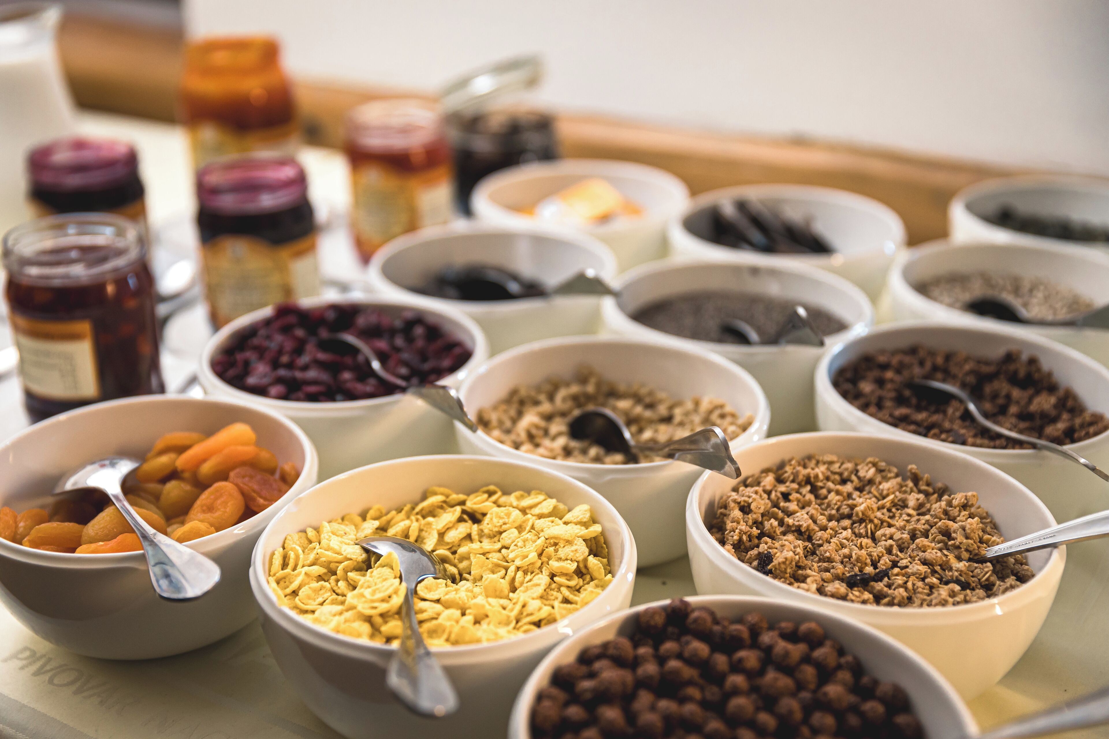 A variety of food items in bowls, including cereals and dried fruits.