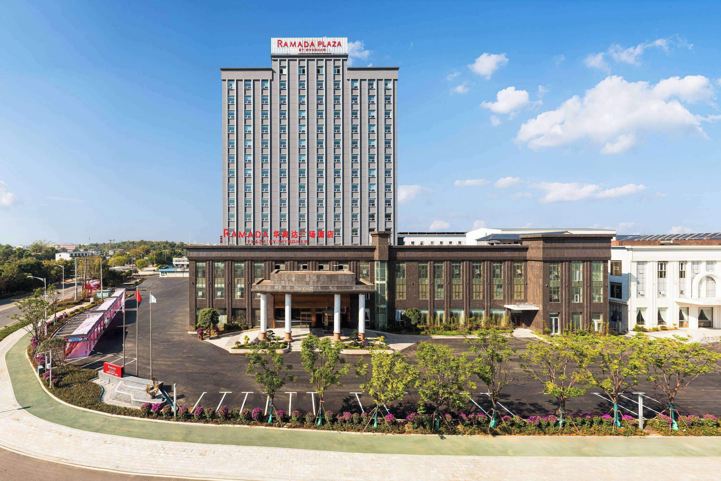 A multi-story hotel with a prominent sign reading "RAMADA PLAZA."