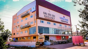 A multi-story building with signage for "Sri Sri Excellence" and "Usha Bari Convention". - Sri Sri Sri Excellency  (Khammam)