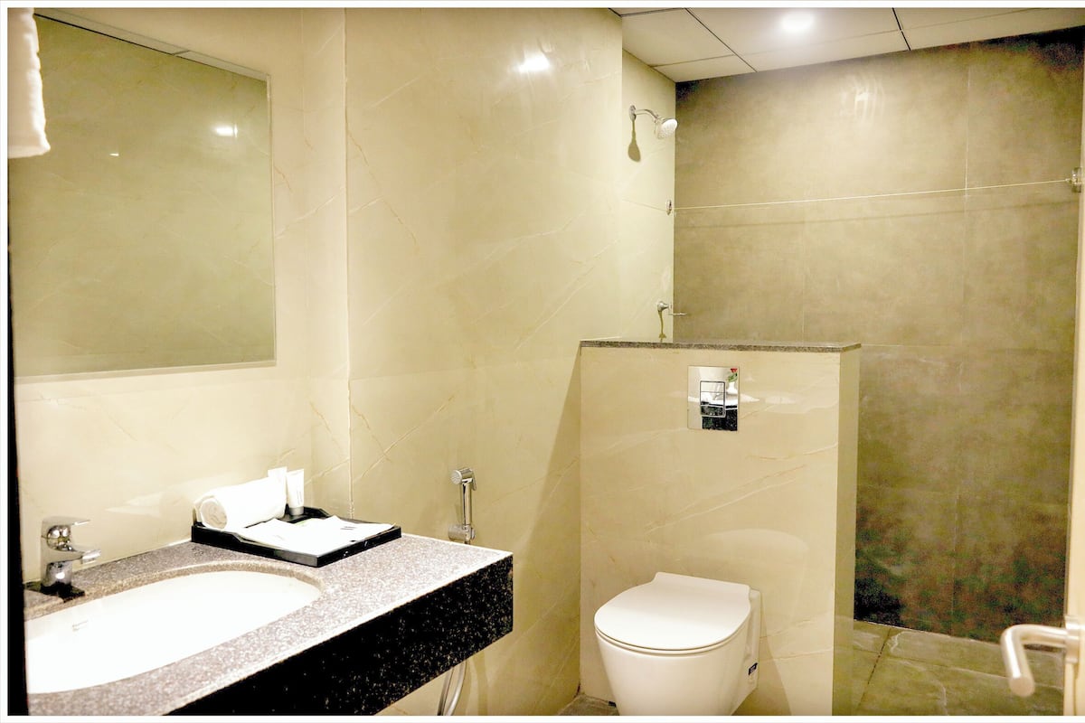 Enjoy a refreshing shower in this bathroom with a shower area, toilet, and sink.