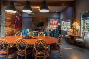 Relax in a spacious living area with a round dining table, comfortable sofas, and a flat-screen TV.