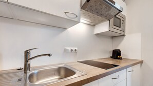 A modern kitchen with a stainless steel sink, a built-in microwave, and a coffee maker on the countertop. - Apartment 'Landhaus Antonius Loft Suite Vitus' with Mountain View, Wi-Fi and Air Conditioning (St. Michael Eppan)