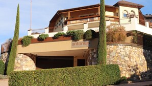 A two-story building with a stone facade, a balcony with plants, and a sign reading 'antonius landhalls'. - Apartment 'Landhaus Antonius Loft Suite Vitus' with Mountain View, Wi-Fi and Air Conditioning (St. Michael Eppan)